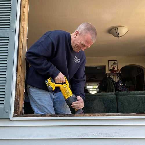 Senior technician finalizing window hardware integration