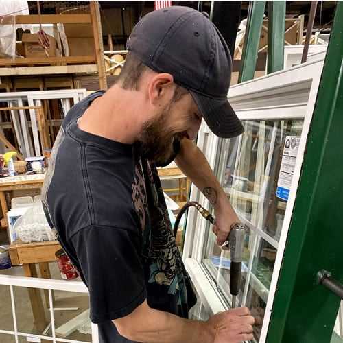 Master craftsman assembling custom architectural window